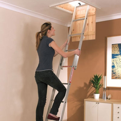 Woman demonstrating how to fit loft ladders