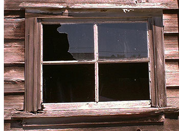A broken window on a shed