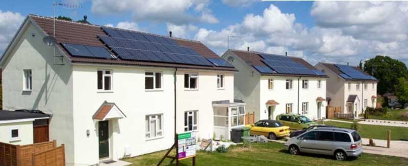 Houses with solar panels on their roofs.