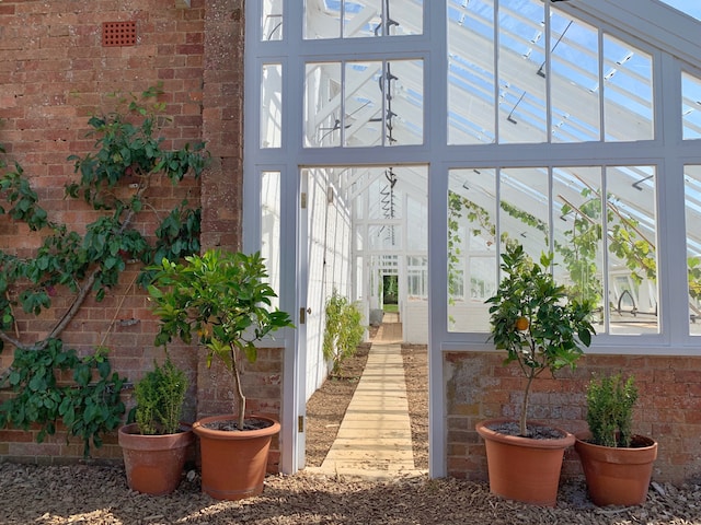 A large attached conservatory with plants.