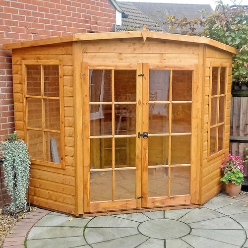 A corner summerhouse with a patio.