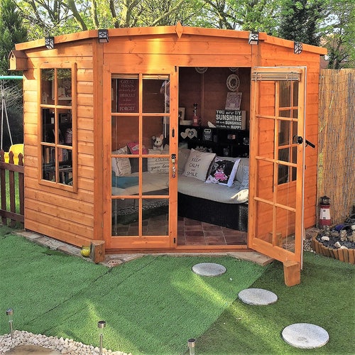 A wooden summer house transformed into a living room.