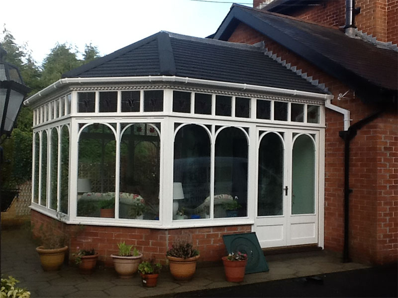 Insulated conservatory with planters outside.
