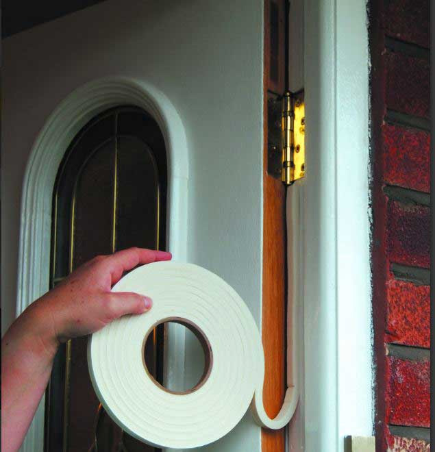 Person draughtproofing an external door.